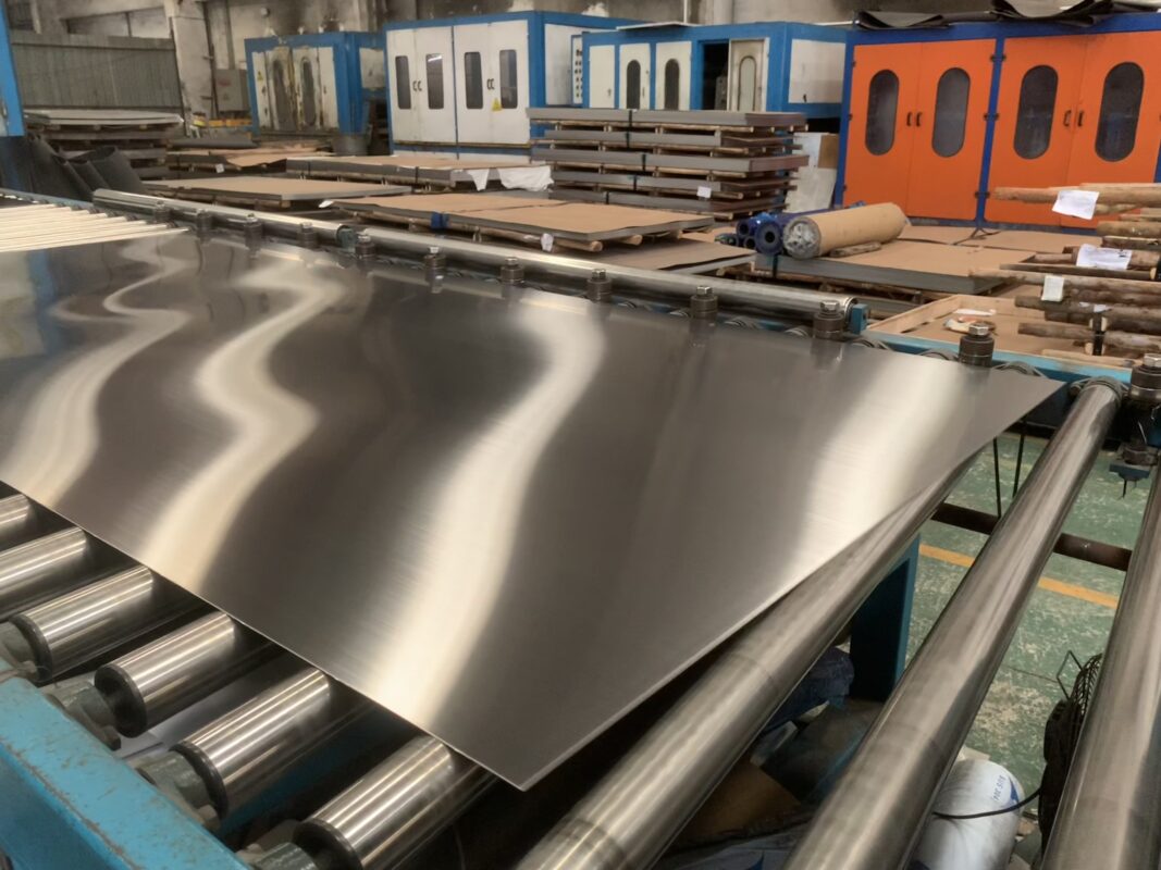 Brushed stainless steel sheet close-up showing fine grain texture and matte finish